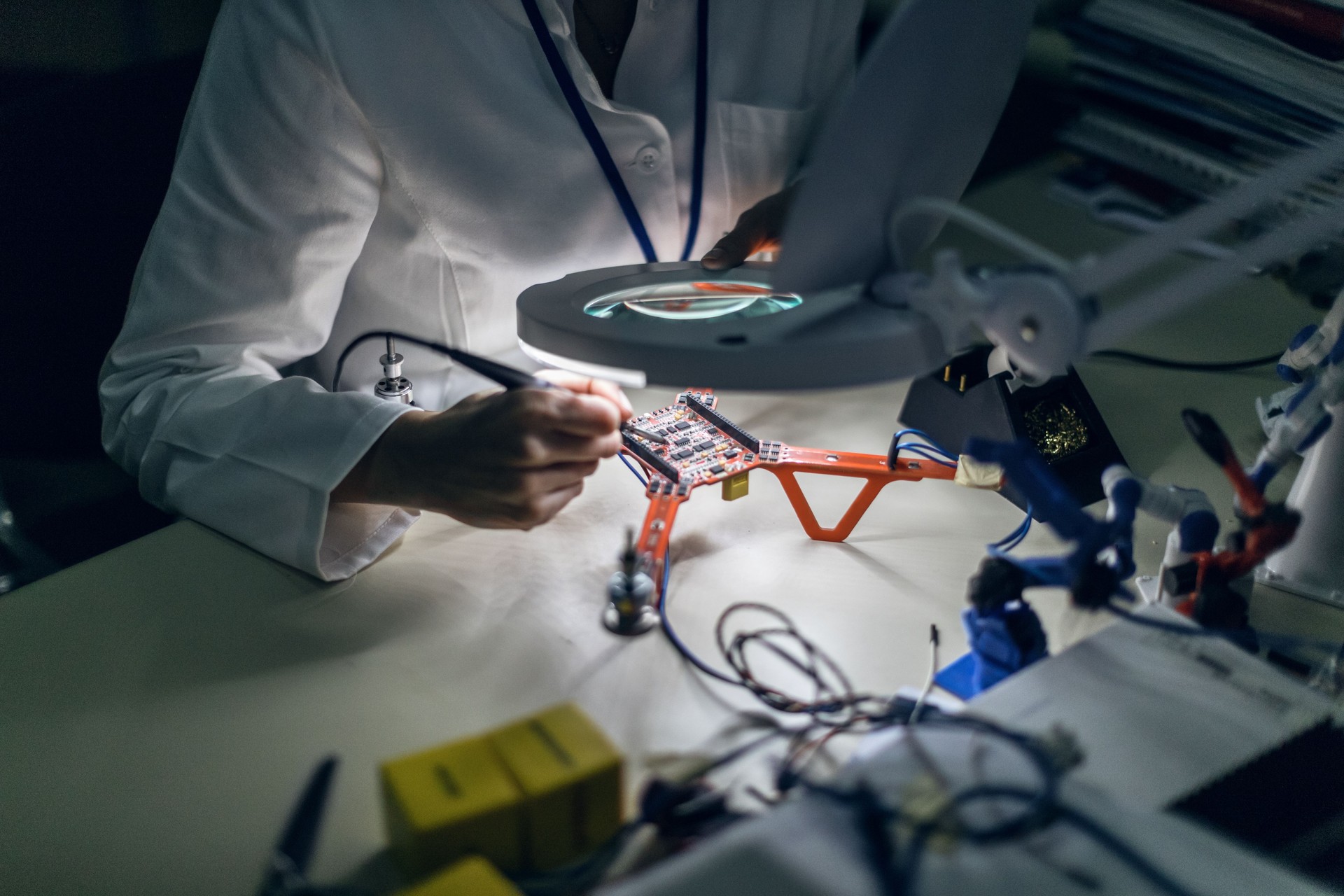 Electrician repairing drone at desk